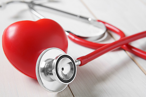 closeup red heart rubber with stethoscope medical instrument on
